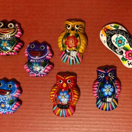 Mexican Ceramic II. Mexican ceramic magnets, charro hats, and metal figures. All with traditional designs.